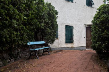 Bulutlu bir günde yüksek çitlerle çevrili bir parkta panoramik patika.