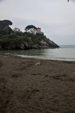 Bulutlu bir günde, deniz kenarında bir kumsalda