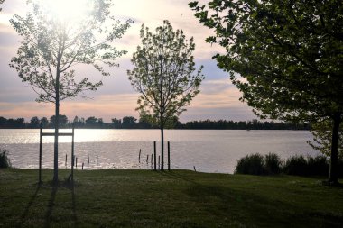 Gün batımında gölün kıyısına park et.