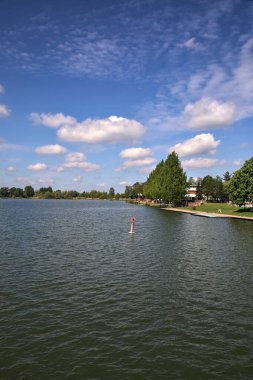 Güneşli bir günde bir gölün kıyısında demirli bir sahil.
