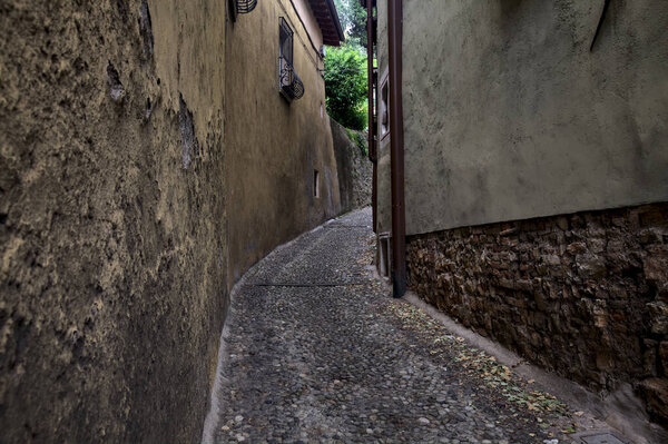 Very narrow cobbled alley in an italian town