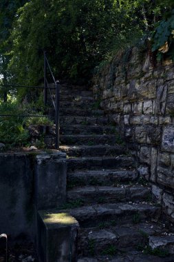 Stone staircase made in a stone wall in a park