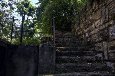 Stone staircase made in a stone wall in a park