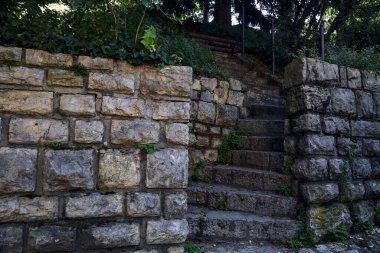 Stone staircase made in a stone wall in a park