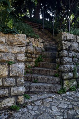 Stone staircase made in a stone wall in a park