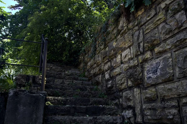 Stone staircase made in a stone wall in a park