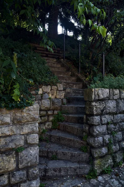 Stone staircase made in a stone wall in a park