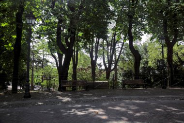 Square with benches by a balustrade in a park