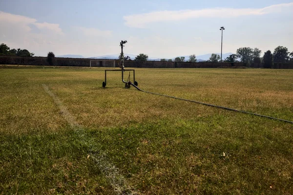 Sprinkler Edge Worn Football Field Sunny Day — Stockfoto