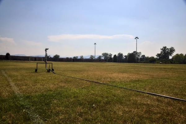 Sprinkler Edge Worn Football Field Sunny Day —  Fotos de Stock