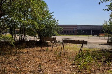 Bare open space in a grove with bars blocking it