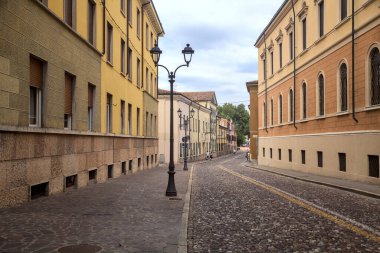 Downward cobbled street on a cloudy day