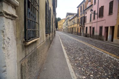 Downward cobbled street on a cloudy day