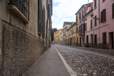 Downward cobbled street on a cloudy day