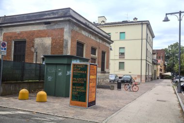 Brick utility building in a square on a cloudy day