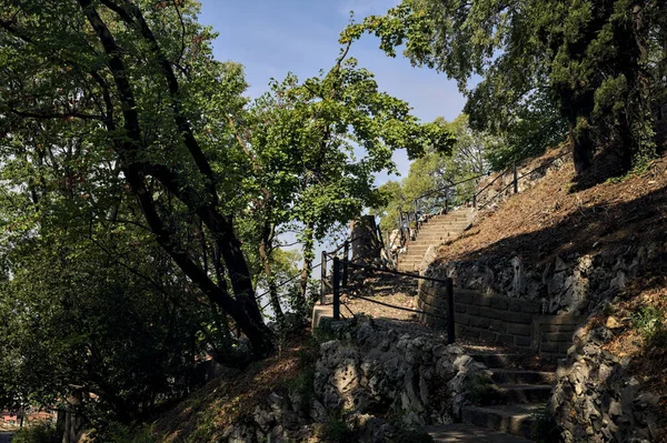 Stone staircase by the edge of a slope in a park