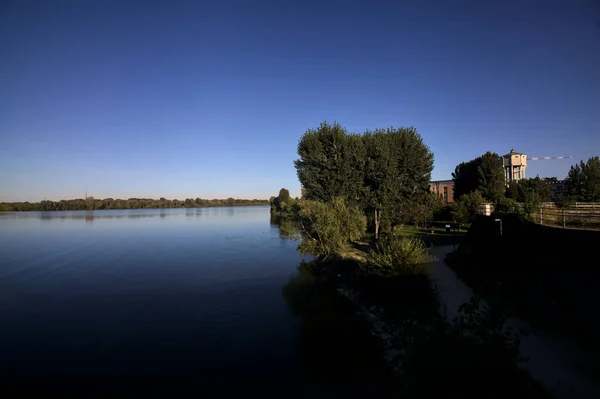 Lake with trees by the shore at sunset seen from above