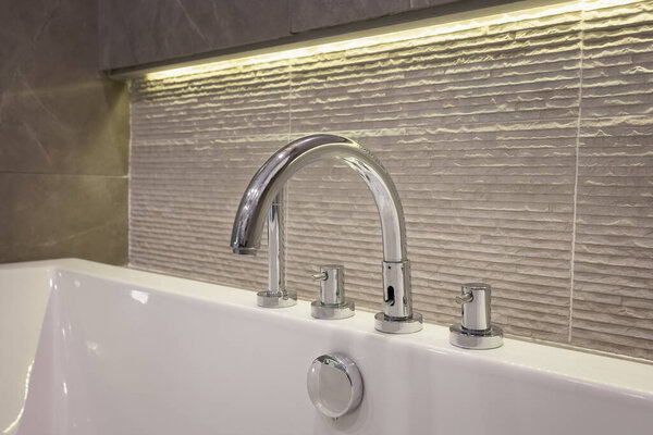 closeup faucet and bathtub in bathroom