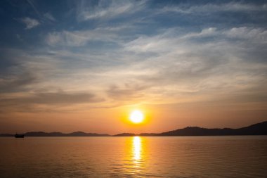 beautiful sunset view above sea with mountain and nice sky