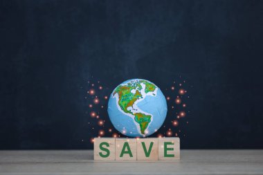 wood cube block with SAVE word and globe model on dark blue background, environment preservation concept