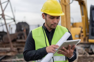 İnşaat alanında çalışan mühendis. İnşaat alanında çalışan genç bir işçi. İnşaat ve inşaat mühendisi kavramı.