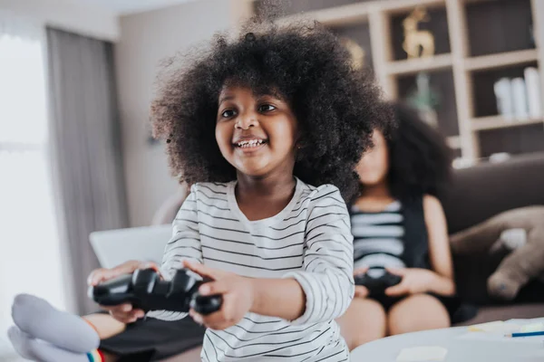 Happy african family having Fun together at Home. African kids daughter playing game with her family in living room. Happy family time.