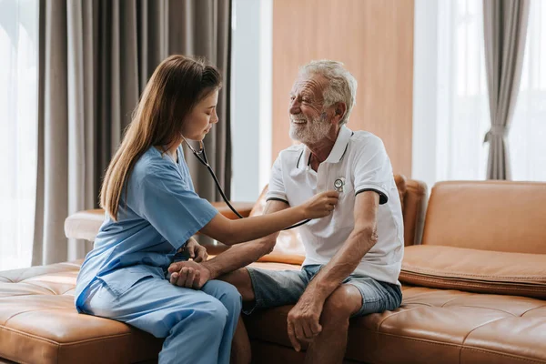 Young nurse caring elderly man at home. asian nurse helping senior man at home. Senior health care.