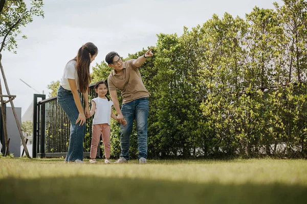 Family having fun time at home. Asian family with little kids daughter playing together in house backyard outside. Happy family time.