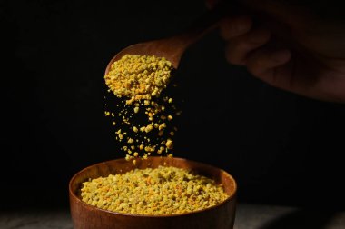 Raw Amorphous Pollen On A Wooden Spoon in Studio