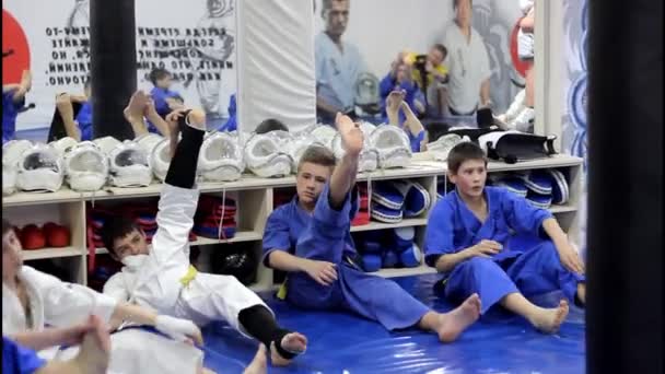 Rússia, Stavropol Clube de esportes Olympus, 04.07.2017 Atletas em quimono se aquecem durante o treinamento em artes marciais, KUDO. — Vídeo de Stock