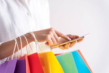 Kadın eli çantanın renginde ve akıllı telefon kullanıyor.