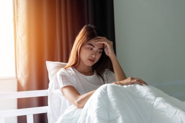Yatakta oturan stresli kadın