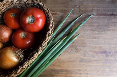 Tahta masada soğan ve domates.