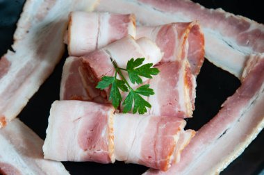 Delicious bacon on top of a dark background