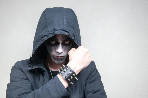 Young man with facial paint on a white background