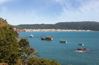 Sahilde arka planda şehir olan teknelerin görüntüsü