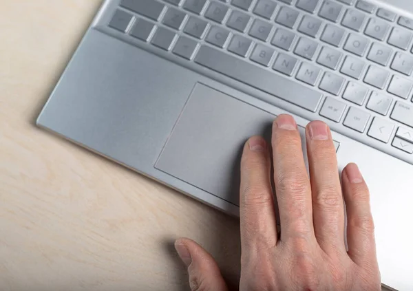 Hand on laptop touchpad, tapping and scrolling with fingers closeup — Stock Photo, Image