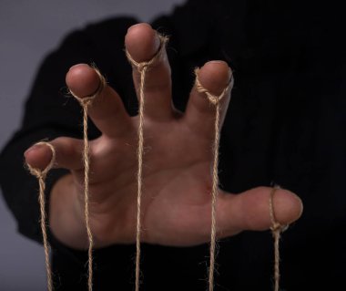 Manipulation concept. Hand of abuser manipulate and dominate