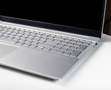 Laptop keyboard and screen closeup. Silver keypad details