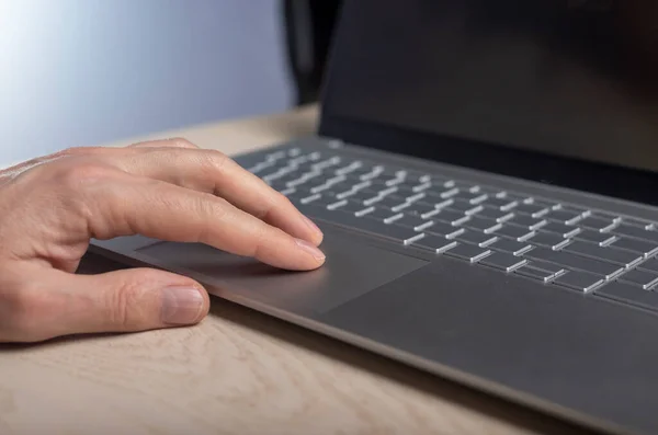Hand on laptop touchpad, tapping and scrolling with fingers close up — Stock Photo, Image