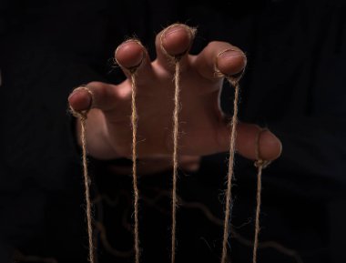 Manipulation concept. Hand of abuser manipulate and dominate