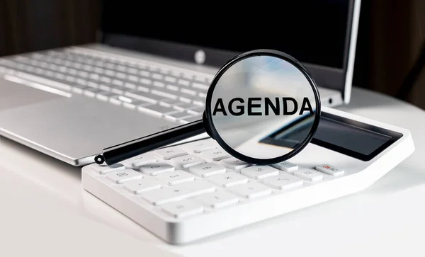 Agenda word through magnifying glass. Business concept — Stock Photo, Image