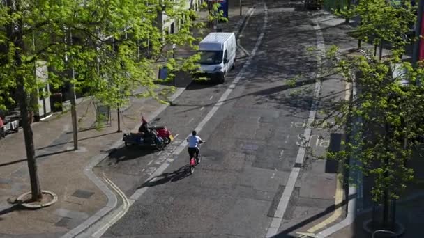 "Camera tracks a cyclist along a quiet London street — Stock Video