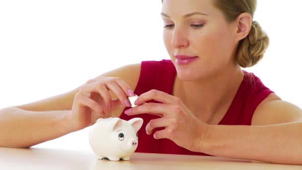 Woman Putting Money Piggy Bank — Stock Video