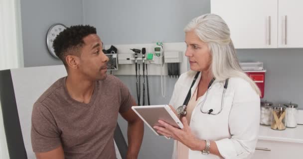 Portrait Young Black Man Consulting Mature Female Doctor Indoors Medical — Stock Video
