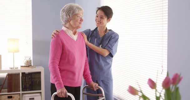 Asian Nurse Elderly Woman Patient Looking Out Window — Stock Video