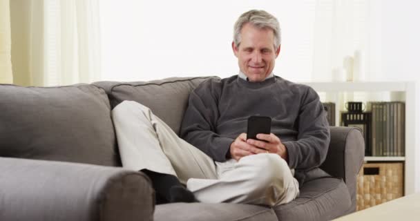 Senior Man Using Smartphone Smiling — Stock Video