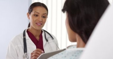 Kadın doktor İspanyol hastaya tablet bilgisayar ile konuşmak
