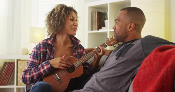 Cute Black Girlfriend Serenading Her Boyfriend Ukulele — Stock Video