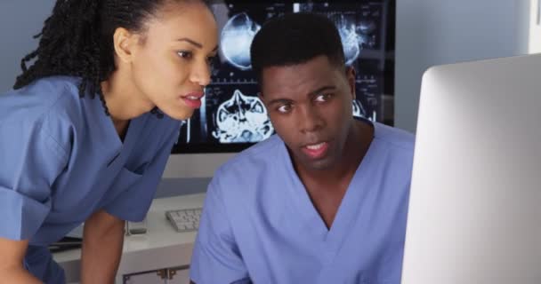 Two African American Medical Specialists Using Computers — Stock Video